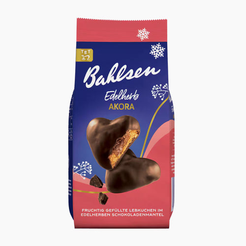 A package of Bahlsen Dark Chocolate Akora gingerbread hearts, featuring a blue and pink bag with illustrations of snowflakes and a cut-open heart cookie showing a fruit filling.