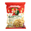 Almdudler Almpops popcorn packaging with illustration of two people and popcorn graphics.