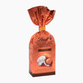 A package of Lindt Christmas Almonds Classic, featuring classic German chocolate candies wrapped in metallic copper foil and tied with a gold ribbon, set against a plain white background.