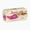 A box of Amicelli Haselnuss Creme ( hazelnut cream) wafer rolls on a clean white background. The packaging is cream-colored with a prominent purple label and illustrations of hazelnuts and chocolate wafer bars.