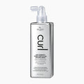 A bottle of Curl Anti-Humidity Shine Coat & Curl Sealing Spray by Hair Chemist, featuring a metallic silver rectangular bottle with a clear spray nozzle, set against a plain light gray background.