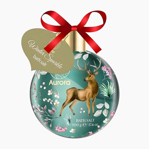 A decorative oval bath salt container with a red ribbon bow and hanging tag. The container is teal with a golden deer illustration, white floral details, and gold text reading 'Aurora' and 'Bath Salt 500 g'.