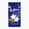 A package of Bahlsen Zimtsterne cinnamon stars cookies on a clean white background. The packaging is dark blue with white icing star illustrations, cinnamon sticks, and a small gold TET logo in the top left corner.