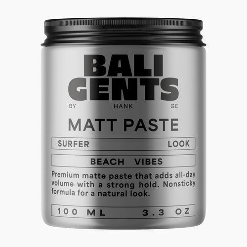 A silver cylindrical jar of Bali Gents Matt Paste with a black screw-on lid, shown on a plain light gray background. The label features black text including 'BALI GENTS', 'MATT PASTE', 'SURFER LOOK', and 'BEACH VIBES'.