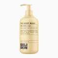 A 250 ml pump bottle of Bali Skin The Body Wash in Warm Tonka & Oud, featuring a warm golden-beige color and black text on a clean white background.