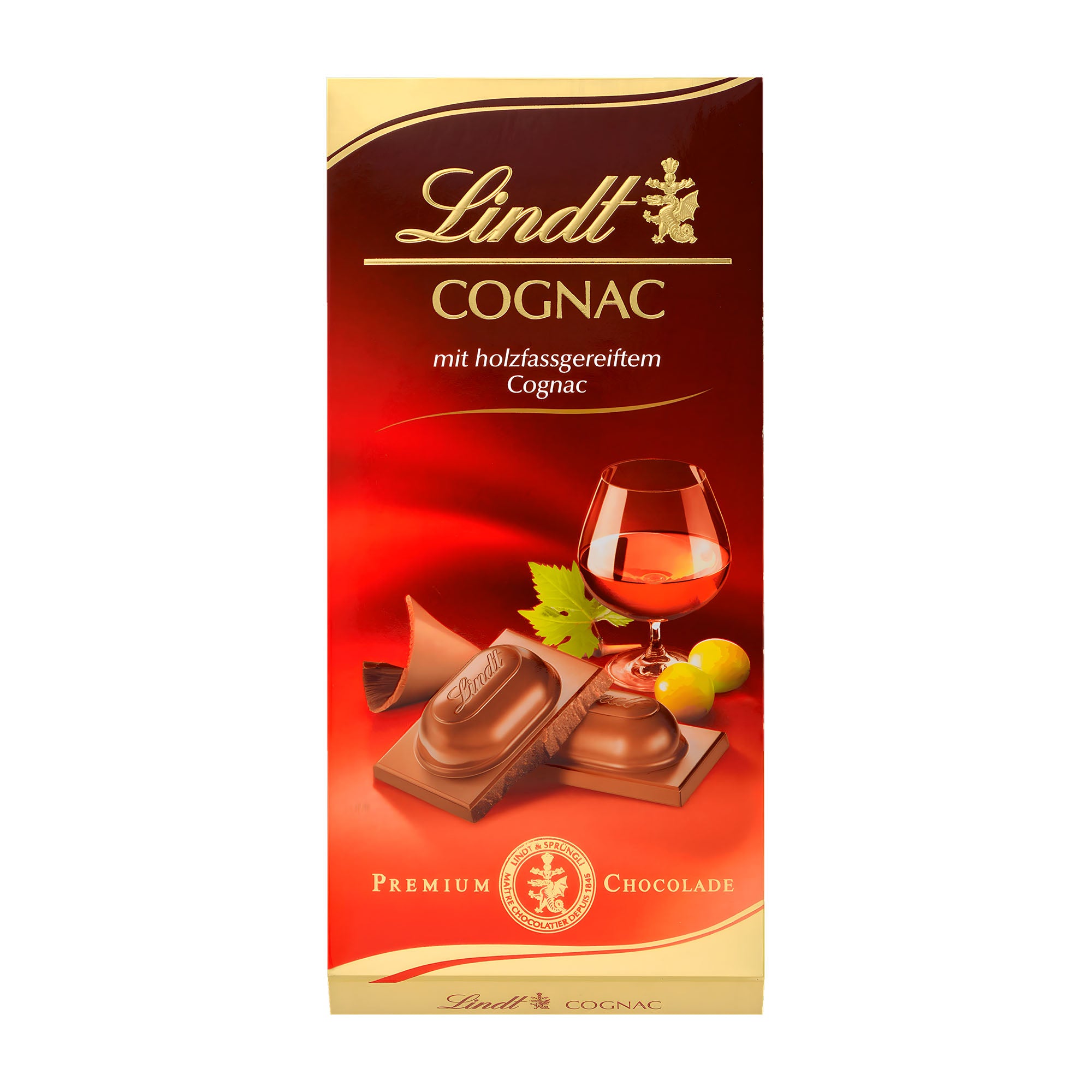 Packaging of Lindt Premium cognac milk chocolate bar, 100 g, showing the bar and a glass of cognac, with leaves of an citrus fruit in the background.