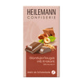 Packaging of Heilemann Gianduja-Nougat with Brittle milk chocolate bar, showing the product and its name, along with images of chocolate pieces, a bar, and a nut.