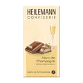 Packaging of Heilemann Marc de Champagne-Truffle milk chocolate bar, 100 g, with an image of the chocolate bar and a glass of champagne on the front.