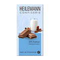 Heilemann Confiserie chocolate packaging with a glass of milk and chocolate pieces on a light blue background