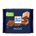 Packaging of Ritter Sport Nougat milk chocolate bar, showing the chocolate bars and pieces with nougat filling on a blue background.