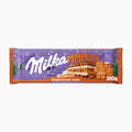Milka MMMAX Gingerbread Taste milk chocolate bar packaging on a light gray background.