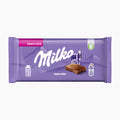 Milka Alpine Milk chocolate bar snack pack on a light gray background.