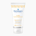 A white squeeze tube of Barnangen Lycka Nutritive Hand Cream with blue and yellow text and yellow floral accents, set against a plain white background.