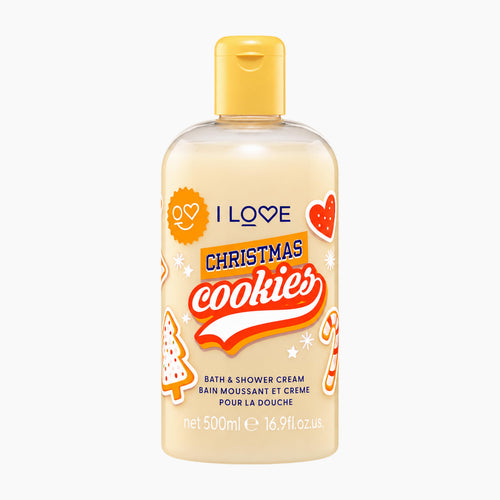 A 500ml bottle of I Love Christmas Cookies Bath & Shower Cream on a solid white background. The bottle is translucent, showing a warm cream-colored liquid inside, and features a yellow cap.