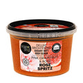 Organic Shop Rose Spritz Deluxe Brightening Pink Grapefruit & Rose body scrub in a clear plastic tub with a black lid, showing the orange scrub inside, on a white background.