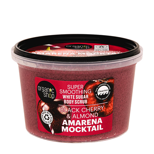 A clear plastic tub of Organic Shop Black Cherry & Almond Amarena Mocktail body scrub, showing the deep reddish-purple scrub inside, with a red and black label and a black lid.