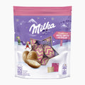 A package of Milka Bonbons Knister in a purple and pink stand-up pouch with a clear window showing the patterned eggs inside.