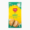 A 1kg package of Schär Brot Mix gluten free bread mix, featuring a bright yellow and green design with an illustration of sliced bread.