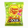 A bag of Chupa Chups Sour lollipops, featuring a bright lime green packaging with a large yellow Chupa Chups logo and illustrations of sour fruits.