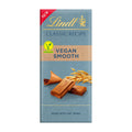 Packaging of Lindt Classic Recipe Vegan Smooth chocolate bar, with the bar and ingredients like almonds and oat drink depicted on the front.