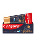Colgate Harry Potter toothpaste tube resting on top of its retail box, shown against a plain white background. The tube is dark navy blue with a metallic gold cap and gold, white, and red branding, while the box is navy blue with a red band and white Colgate logo.