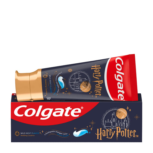 Colgate Harry Potter toothpaste tube resting on top of its retail box, shown against a plain white background. The tube is dark navy blue with a metallic gold cap and gold, white, and red branding, while the box is navy blue with a red band and white Colgate logo.