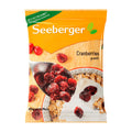 Packaging of Seeberger dried cranberries showing the product name and an image of dried cranberries on a spoon, alongside a bowl of cereal with dried cranberries.