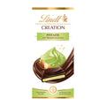 Packaging of Lindt Creation Pistachio dark chocolate bar, showing the product name and an image of the chocolate bar with pistachio cream and almond pieces.