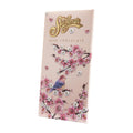 A bar of Stühmer dark chocolate, 90 grams, with floral and bird embossed design on the packaging.