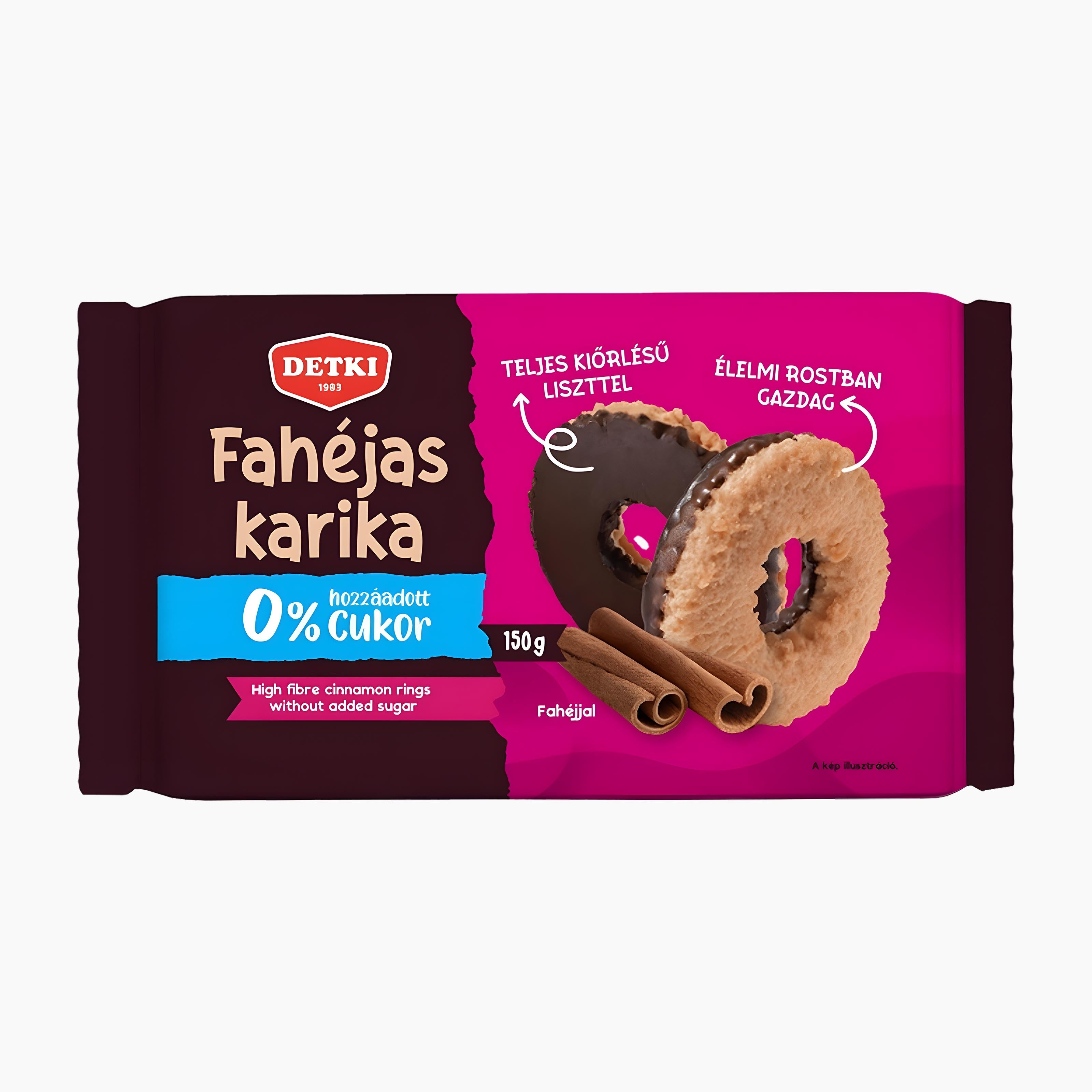 A 150g package of Detki Cinnamon rings on a light gray background. The packaging features a dark brown left half with white text, a bright pink right half with product imagery of chocolate-covered cinnamon rings, and a blue banner indicating 0% added sugar.