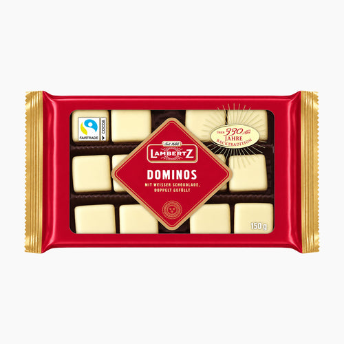 A 150g package of Lambertz White Chocolate Dominos in a red wrapper with gold foil edges, shown on a clean white background.
