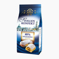 A bag of Elbflorenz Stollenkonfekt Marzipan Stollen Bites, featuring blue packaging with a cityscape illustration, a gold seal, and photos of two filled pastries dusted with powdered sugar.