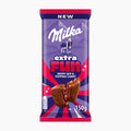 A 150g package of Milka Extra Fun Berry Mix & Popping Candy milk chocolate bar, featuring its signature purple and red wrapper with a cow illustration and chocolate candy graphics, set against a plain white background.