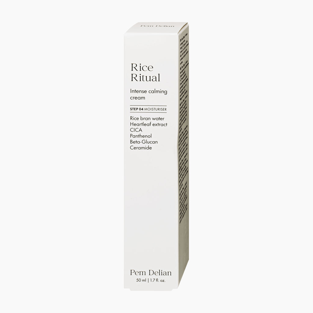A tall, slim white rectangular box of Pem Delian Rice Ritual Intense Calming Cream, featuring black text and a subtle vertical gradient on the side, set against a solid off-white background.