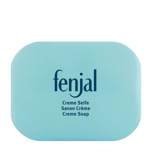 Creme soap with 'fenjal' branding with soap holder on a white background