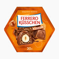 A hexagonal package of Ferrero Küsschen Classic chocolate pralines, featuring an orange design with illustrations of hazelnuts and chocolate pieces, on a light gray background.