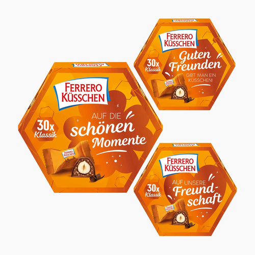 Three Ferrero Küsschen hexagonal chocolate pralines boxes arranged on a light gray background.