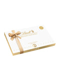 A Lindt gift box with 'Fine Pralines' text, tied with a golden ribbon.