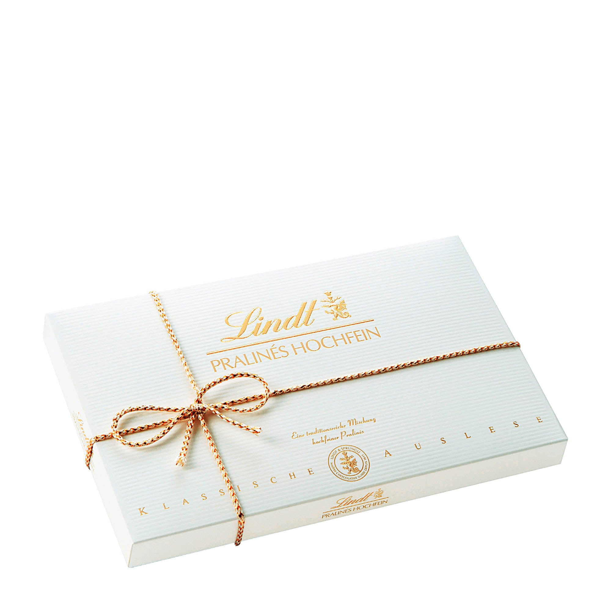 A box of Lindt Fine Pralines with a hand-tied ribbon on top, displaying various types of pralines such as Nut Nougat, Marc de Champagne Truffle, and more.