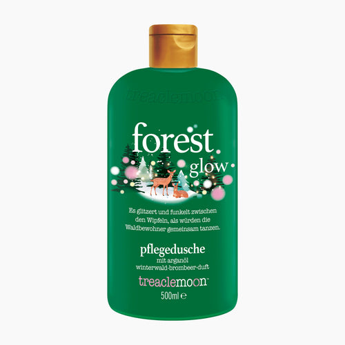 Treacle Moon Forest Glow shower gel in a 500ml green bottle with a gold cap, featuring a festive Christmas tree and deer illustration on the label.