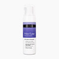 A white pump bottle of John Frieda Frizz Ease Dream Curls styling mousse with a purple and black label, centered on a plain white background.