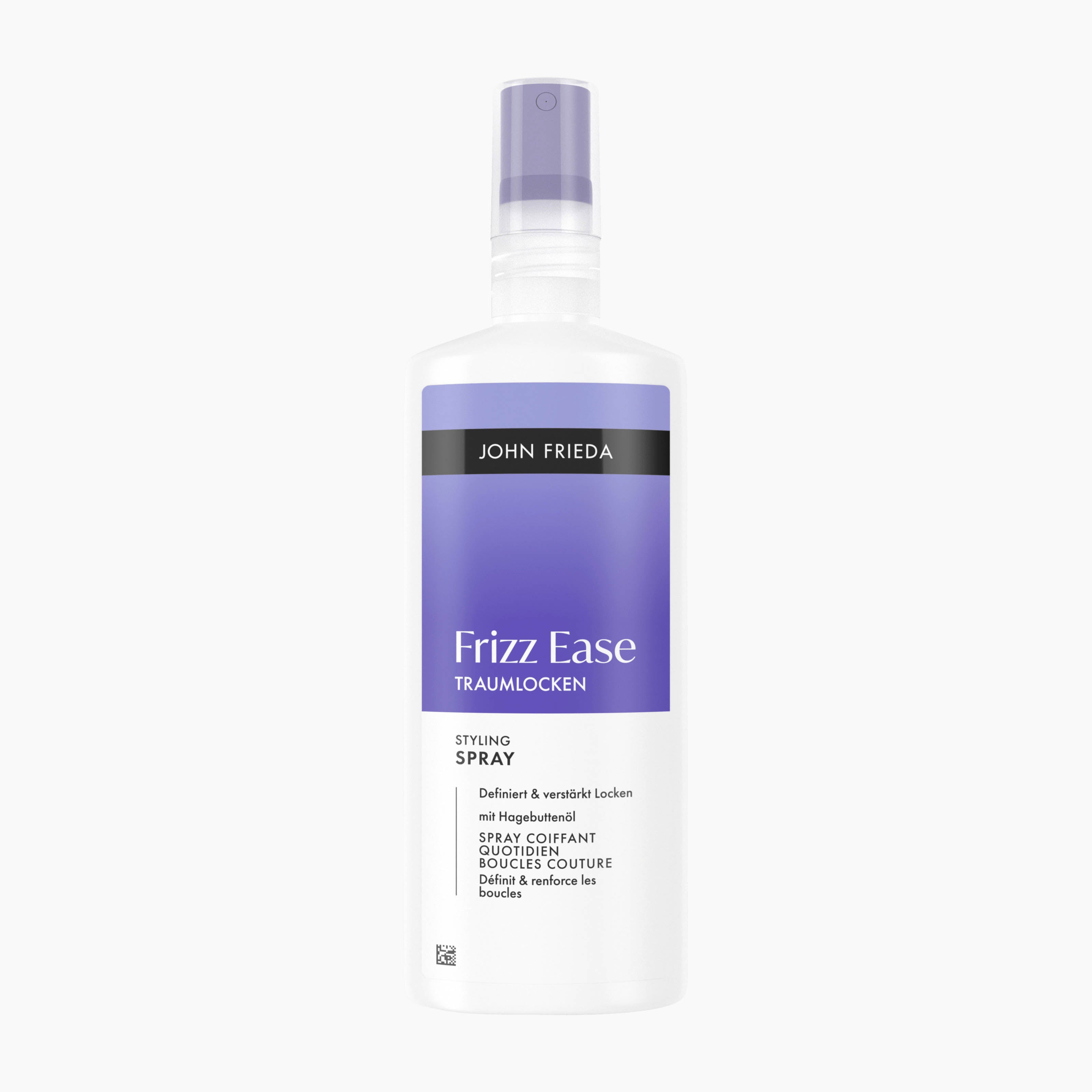 A bottle of John Frieda Frizz Ease Dream Curls Styling Spray hair smoothing treatment, featuring a white bottle with a lavender purple label and spray nozzle, set against a plain white background.