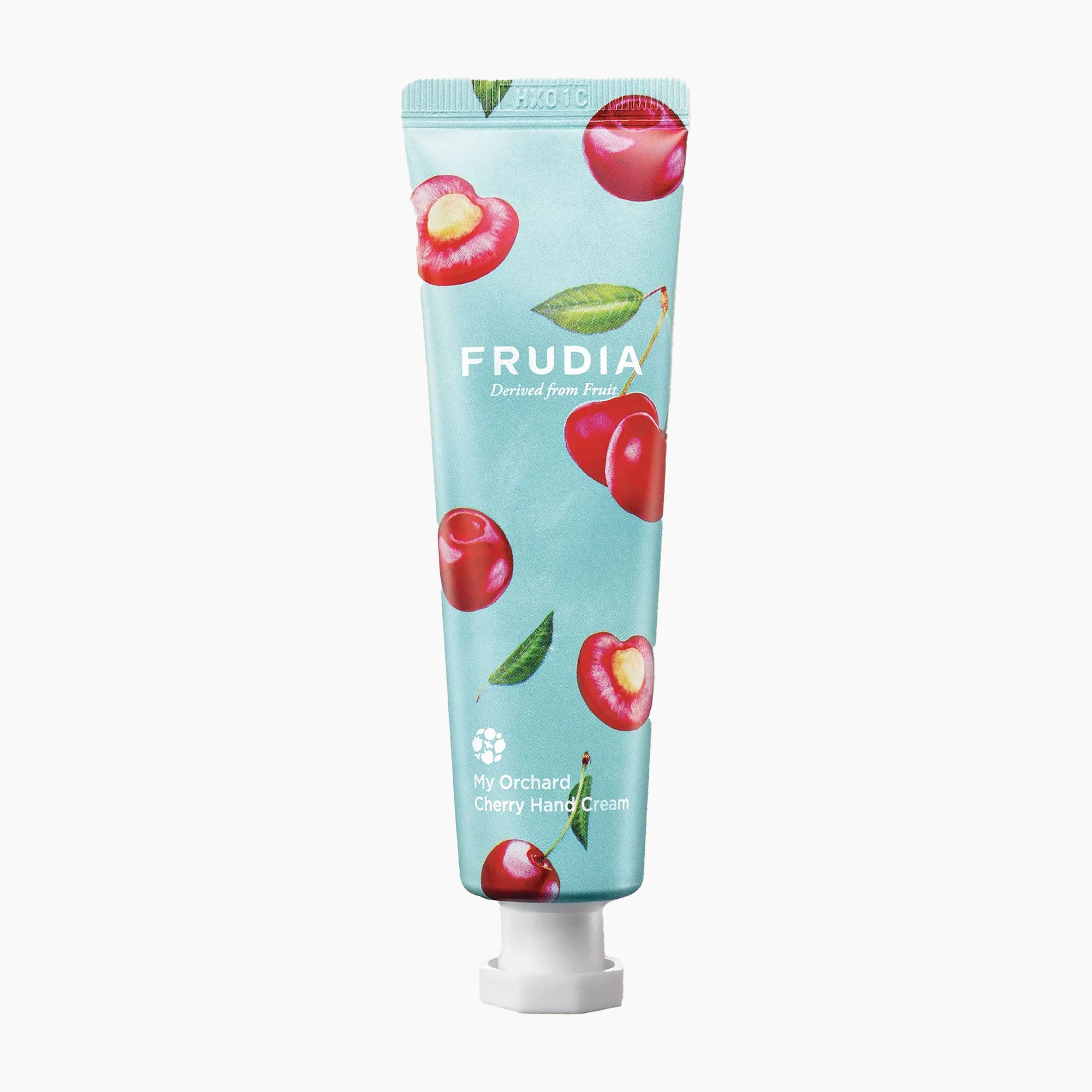 A tube of Frudia Cherry Hand Cream on a clean white background. The tube is light blue with illustrations of red cherries and green leaves, and has a white cap.