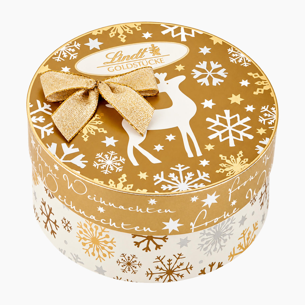 A round Lindt Goldstücke Gold Nuggets Christmas-themed pralines gift box with a gold lid decorated with white reindeer, snowflakes, and stars, topped with a gold glitter bow. The side of the box is white with gold and silver snowflakes and German text.