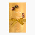 A gold-colored rectangular box of Guylian The Original Seashells chocolates, tied with a matching gold ribbon and bow, with two seashell-shaped chocolates displayed on top, set against a plain white background.