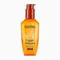 L'Oréal Paris Elvital Oil Magic Jojoba Hair Oil in a clear bottle showing the golden-yellow oil inside, with a metallic copper pump dispenser, on a light gray background.