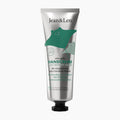 A squeeze tube of Jean&Len Amazing Rosemary & Ginger hand cream with a metallic silver body, a green manta ray graphic, and a black cap, shown on a plain light gray background.