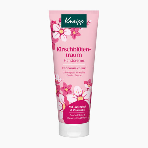 A pink squeeze tube of Kneipp Cherry Blossom Dream Hand Cream with white and pink floral illustrations, set against a plain light gray background.