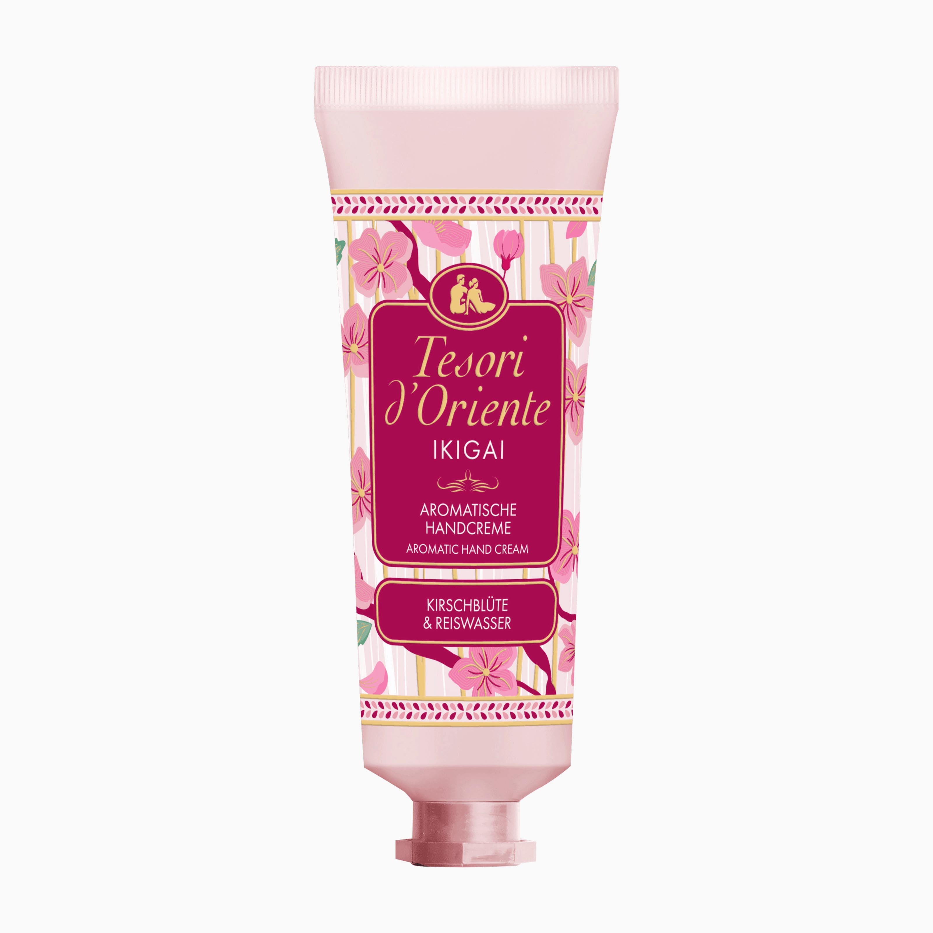 A pink squeeze tube of Tesori d'Oriente Ikigai Aromatic Hand Cream, featuring a floral pattern and a prominent magenta label, set against a plain white background.
