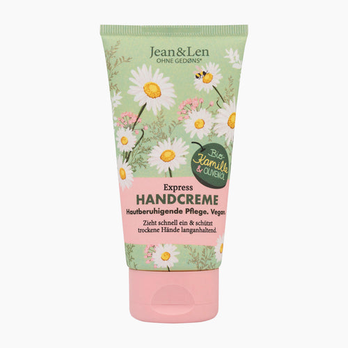 Jean & Len Express Chamomile & Olive Oil Hand Cream tube with a light green background decorated with white daisies, yellow centers, and a pink lower section on a light gray background.